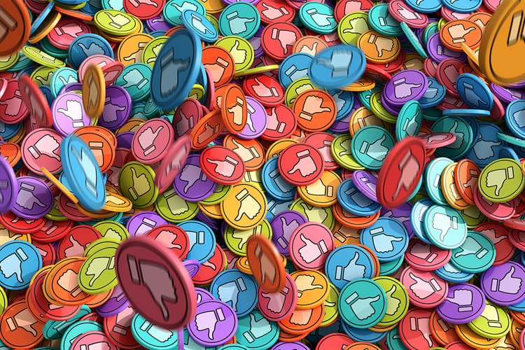 Brightly colored plastic discs printed with social media "like" thumbs up symbol