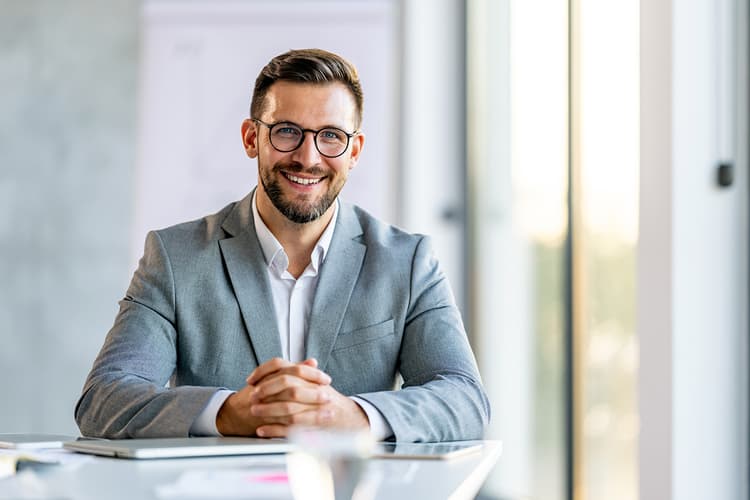 Man in suit smiling at off-camera client