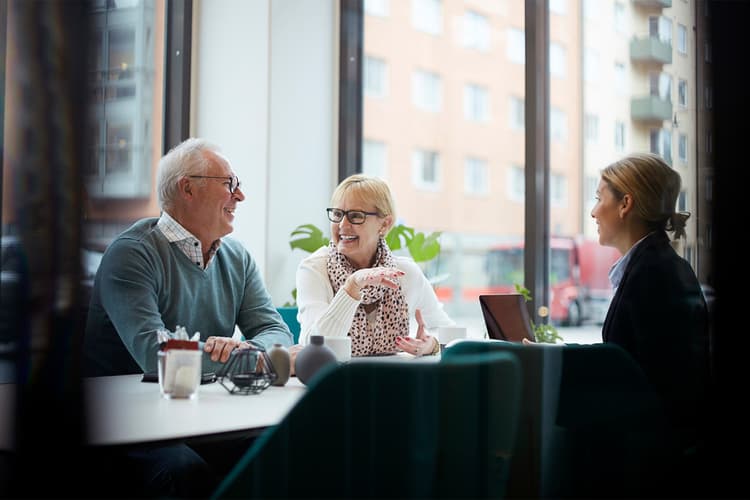 Senior couple at a table with a young woman