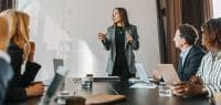 Woman Giving Presentation in Front of Colleagues